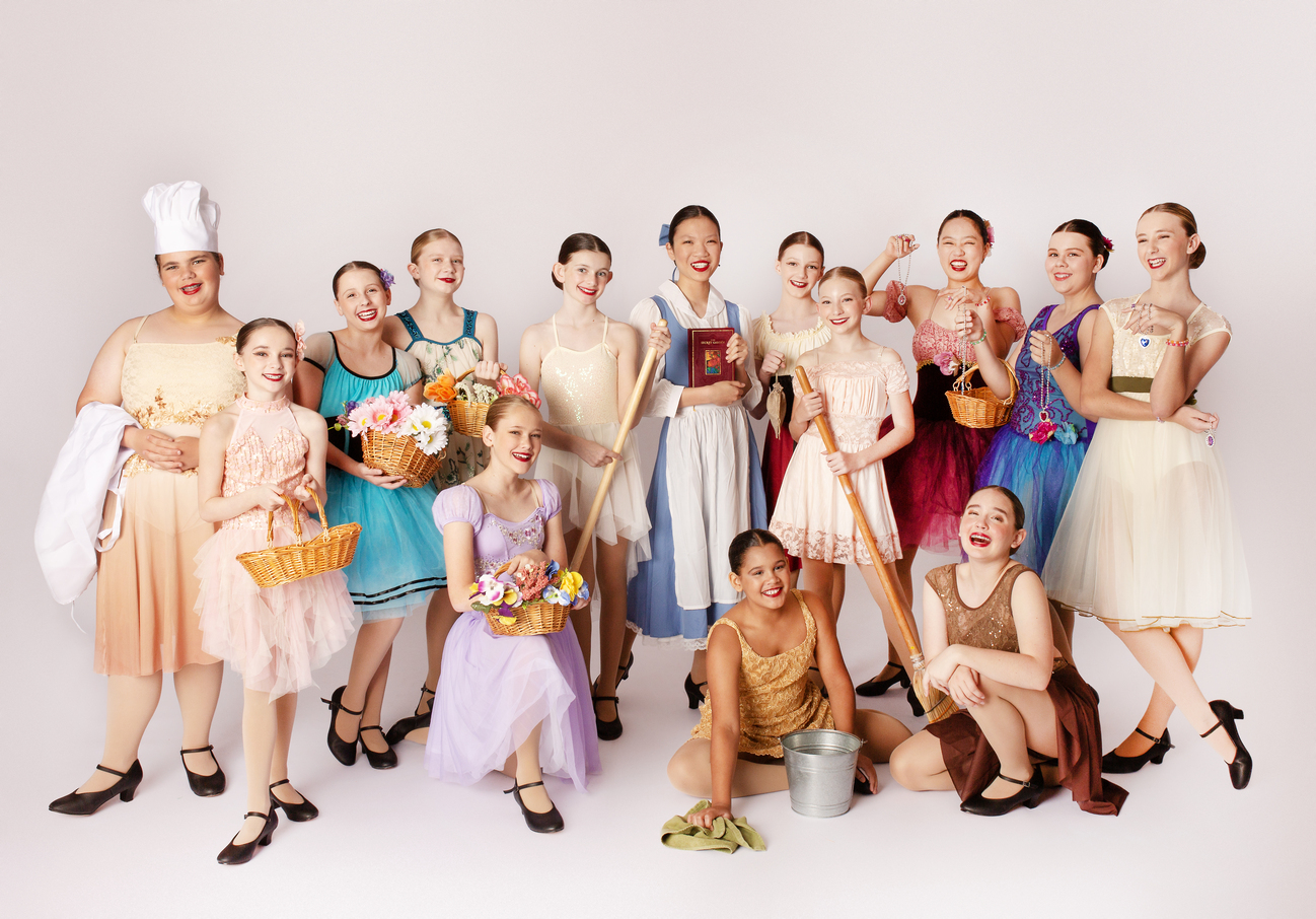 dancers in costume holding dance sign